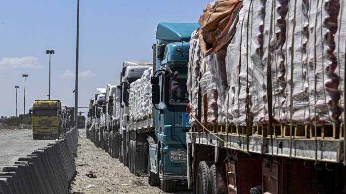  Egyptian trucks carrying humanitarian aid bound for the Gaza Strip queue outside the Rafah border crossing on the Egyptian side on March 23, 2024. 